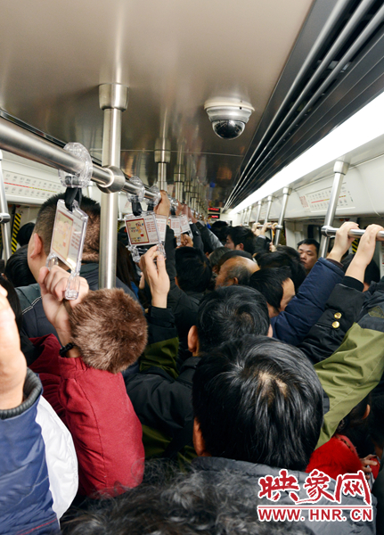 第一趟地铁车厢内挤满了乘坐的市民
