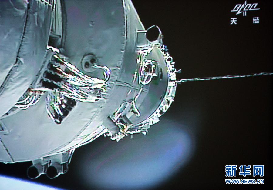资料图：6月13日拍摄的北京航天飞行控制中心大屏幕显示，神舟十号与天宫一号对接。