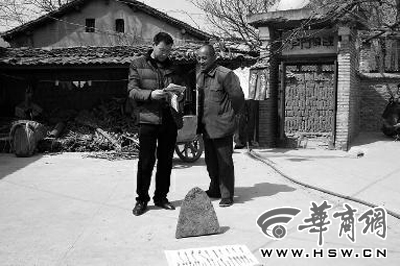 昨日，商洛市博物馆工作人员（左）向李老汉讲解最近出台的《陕西省群众保护文物奖励办法》