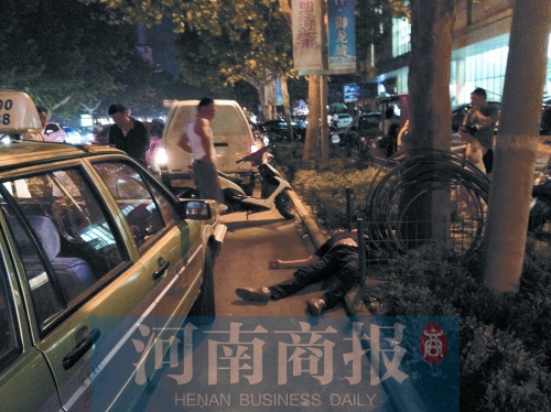 醉汉拳打的哥后耍赖趟地上不起来 民警开车将其拉走