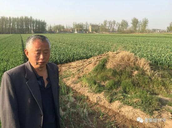 路作义指认儿媳谢来梅的空坟。在6年前,她的尸体被盗走。