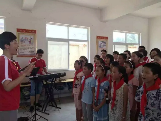 “长亭外，古道边，芳草碧连天……”孩子们在志愿者的伴奏下一起演唱歌曲