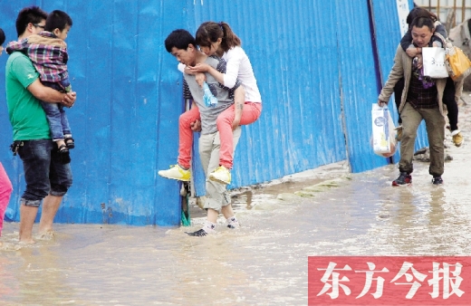雨后郑州，“背人过河”成了一道甜蜜又无奈的风景 东方今报记者 沈翔 摄