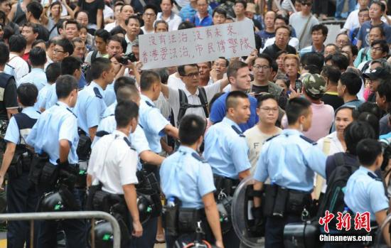 10月22日，有反对“占中”的市民前往旺角的非法占领区展示横额，支持香港警队。中新社发 谭达明 摄