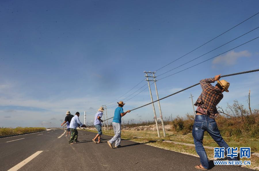 7月22日，海南省文昌市昌洒镇工作人员在清理公路上的电缆。