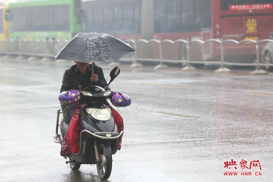 打伞骑行的市民大有人在，存在安全隐患。