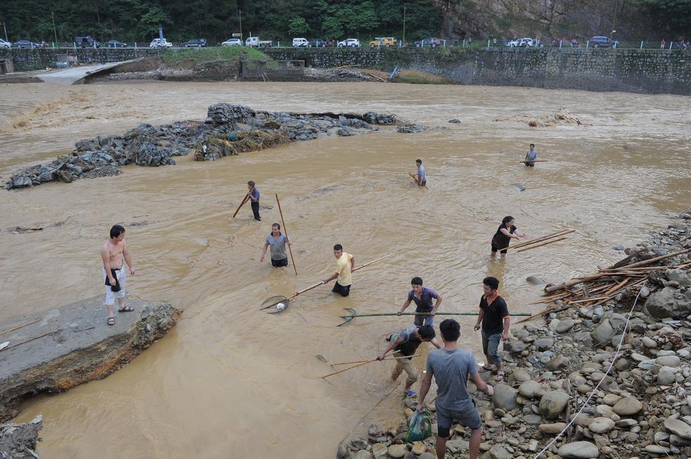 贵州雷山遭暴雨袭击 村民在洪水中淡定捞鱼