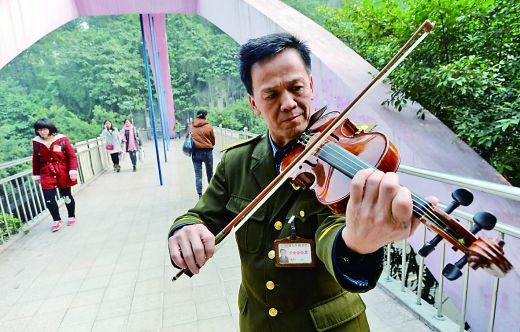 昨日，西南大学，保安曾大珩在天桥上拉小提琴。 重庆晨报记者 胡杰 摄